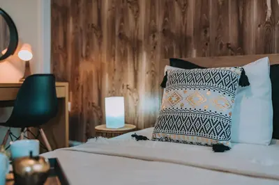 a bedroom with a bed with a pillow and a lamp at 4BED Apartment in the heart of Athens in Athens