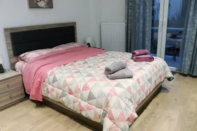 a bedroom with a bed with two pillows on it at Golemis Apartments in Athens