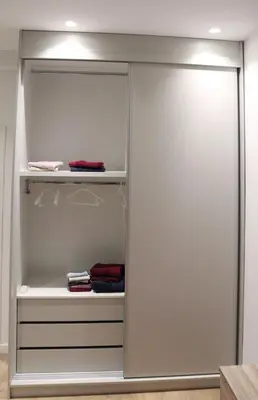 a walk in closet with sliding glass doors at Golemis Apartments in Athens