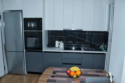 a kitchen with a bowl of fruit on a table at Golemis Apartments in Athens