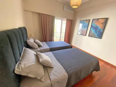 a bedroom with two beds and a couch at Agora Apt2, Metro Station, 2 bdrms in Athens