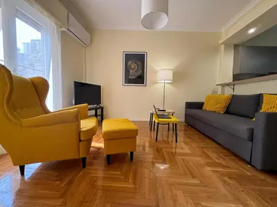 a living room with a couch and a tv at Cecilia's cozy flat in Athens