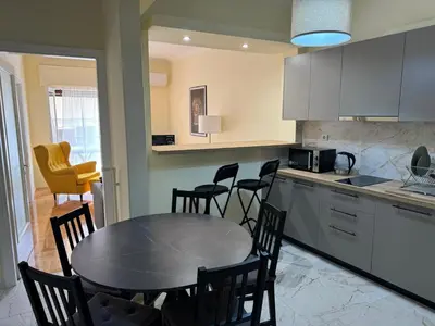 a kitchen with a table and chairs in a kitchen at Cecilia's cozy flat in Athens