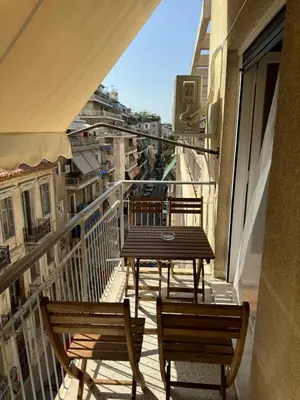 a table and chairs on a balcony with a view at Cecilia's cozy flat in Athens