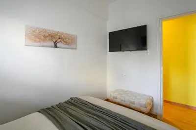 a bedroom with a bed and a tv on the wall at Serene City Hideaway with Balcony & Modern Comfort in Athens