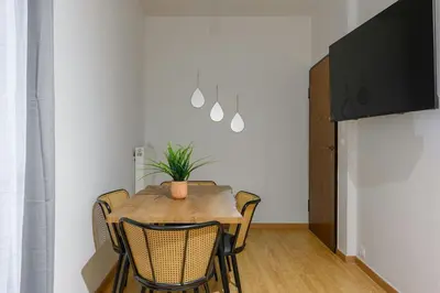 a dining room with a wooden table and chairs at Serene City Hideaway with Balcony & Modern Comfort in Athens