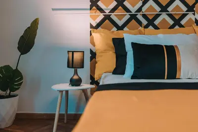 a bedroom with a bed with a lamp and a plant at 4BED apartment in the center of Athens in Athens