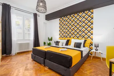 a bedroom with a large yellow and black bed at 4BED apartment in the center of Athens in Athens