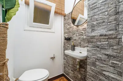 a bathroom with a sink and a toilet and a mirror at 4BED apartment in the center of Athens in Athens