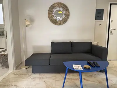 a living room with a couch and a table at Cecilia's cozy apartment in Athens