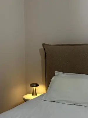 a bed with a pillow and a lamp next to it at In the heart of Athens in Athens