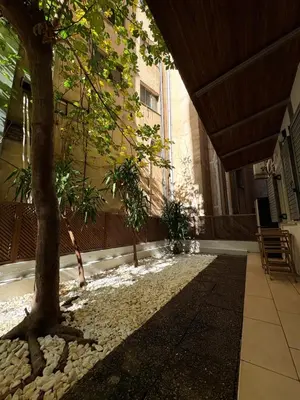 a tree in the courtyard of a building at In the heart of Athens in Athens