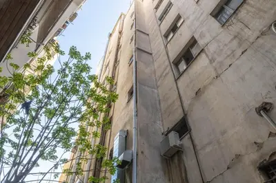 a tall building with plants growing on the side at In the heart of Athens in Athens