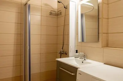 a bathroom with a sink and a shower at In the heart of Athens in Athens