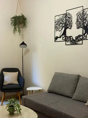 a living room with a couch and a chair at In the heart of Athens in Athens