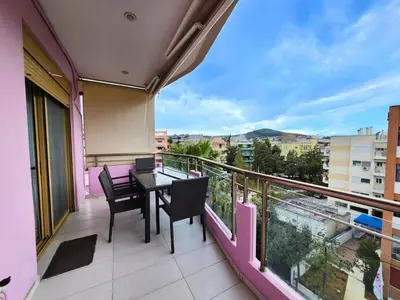 a balcony with a table and chairs and a view at Tender Bliss in Athens