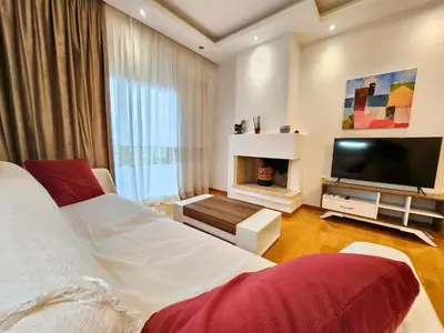 a bedroom with two beds and a flat screen tv at Tender Bliss in Athens