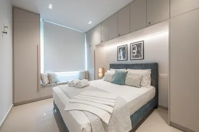 a bedroom with a large bed and a large window at Exclusive Suite by CloudKeys in Athens
