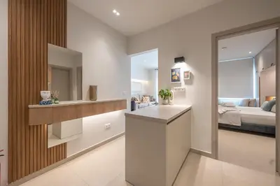 a bathroom with a sink and a bedroom at Exclusive Suite by CloudKeys in Athens