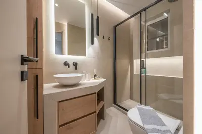 a bathroom with a sink and a shower and a toilet at Exclusive Suite by CloudKeys in Athens