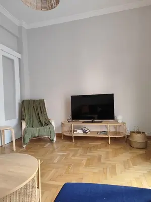 a living room with a flat screen tv on a table at Freshly Renovated Appartment in Athens