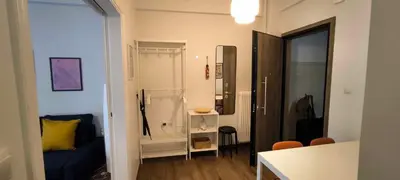a small living room with a blue couch and a table at Freshly Renovated Appartment in Athens
