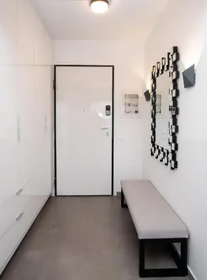 a room with a bench in front of a door at Apartment by the beach in Anavissos
