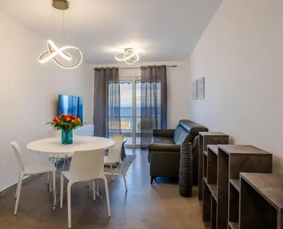 a living room with a table and a couch at Apartment by the beach in Anavissos