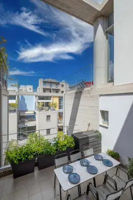 a patio with a table and chairs on a balcony at Award-winning Yellow-spot in Athens