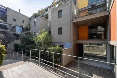 an apartment building with a staircase in front of it at Award-winning Yellow-spot in Athens
