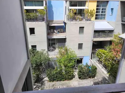 an apartment building with plants on the balconies at Award-winning Yellow-spot in Athens