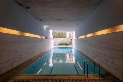 a swimming pool with two faucets in a house at Award-winning Yellow-spot in Athens