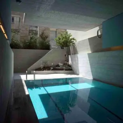 a swimming pool with blue lighting in a building at Award-winning White-spot in Athens