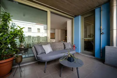 a living room with a couch on a balcony at Award-winning White-spot in Athens