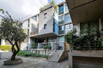 an apartment building with a tree in front of it at Award-winning White-spot in Athens