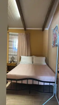 a bed in a small room with a window at Seven stars Camping Evelina in Keratea
