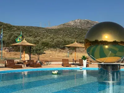 a pool with a large ball on top of it at Seven stars Camping Evelina in Keratea