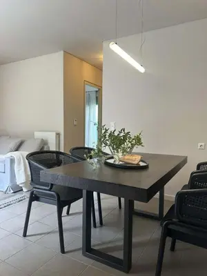 a dining room with a table and some chairs at Amanda Blue in Athens