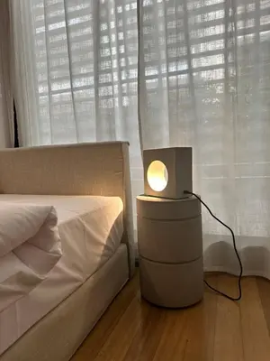 a lamp on a night stand next to a bed at Amanda Blue in Athens