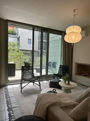 a living room with a couch and chairs and a large window at Amanda Blue in Athens