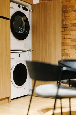 a washer and dryer in a kitchen with a chair at G Residence in Athens