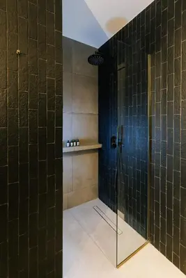 a bathroom with a shower with a glass door at G Residence in Athens
