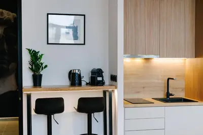 a kitchen with two stools and a counter with a sink at G Residence in Athens