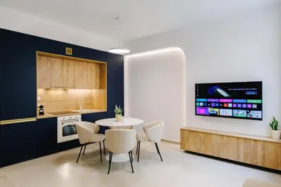 a kitchen with a table and chairs and a tv at Y Residence in Athens