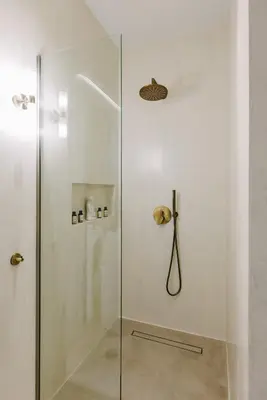 a shower with a glass door in a bathroom at Y Residence in Athens