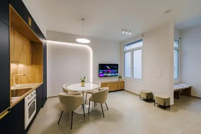 a kitchen and dining room with a table and chairs at Y Residence in Athens