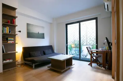 a living room with a couch and a table at The studio in the heart of Athens-Plaka in Athens