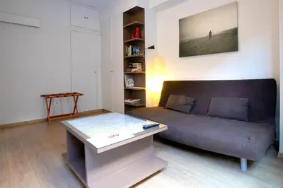 a living room with a couch and a coffee table at The studio in the heart of Athens-Plaka in Athens