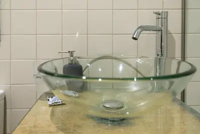 a glass bowl sink on a counter in a bathroom at The studio in the heart of Athens-Plaka in Athens