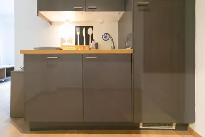 a kitchen with black cabinets and a counter top at The studio in the heart of Athens-Plaka in Athens